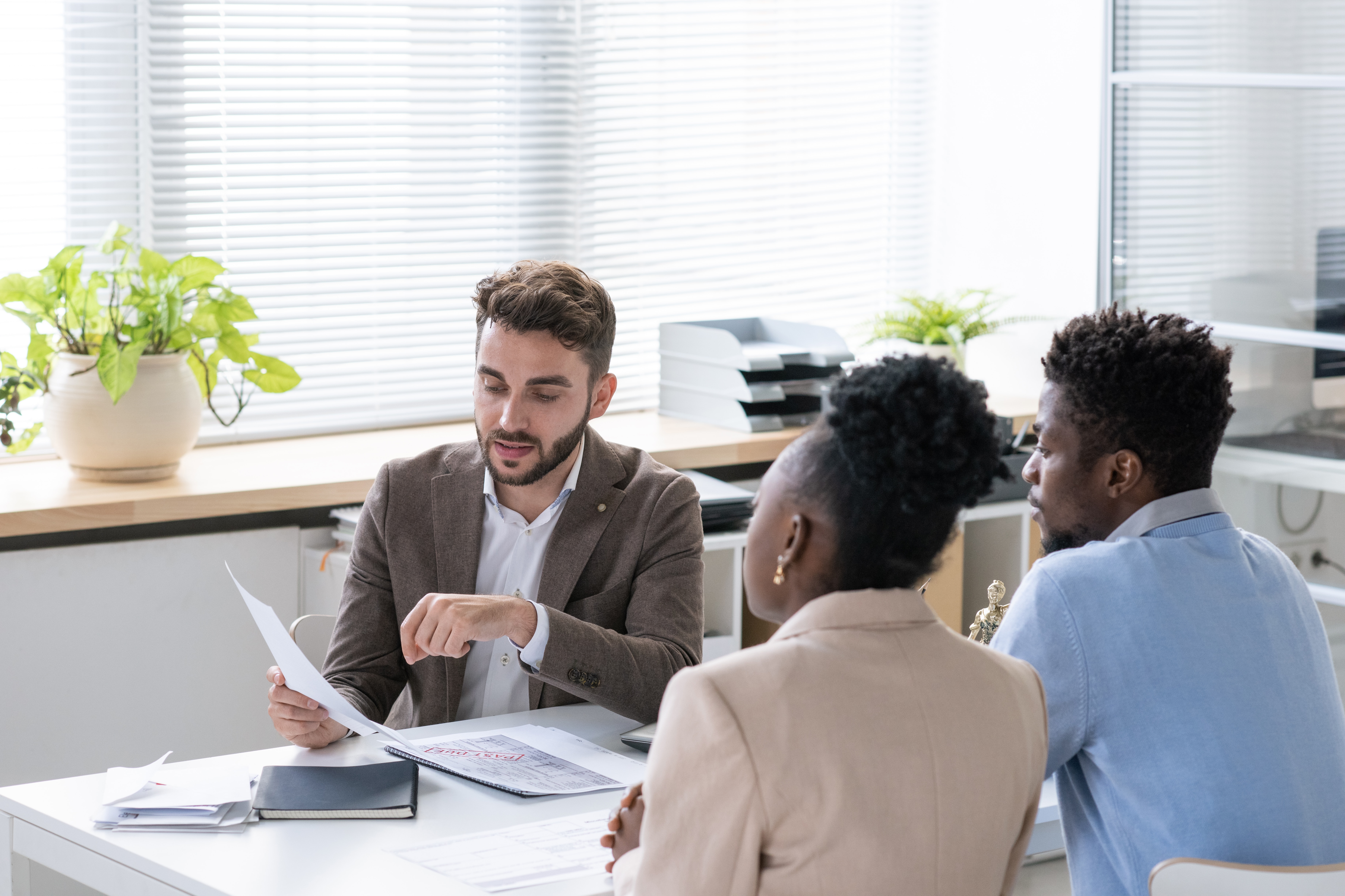 Lawyer discussing a document with two people